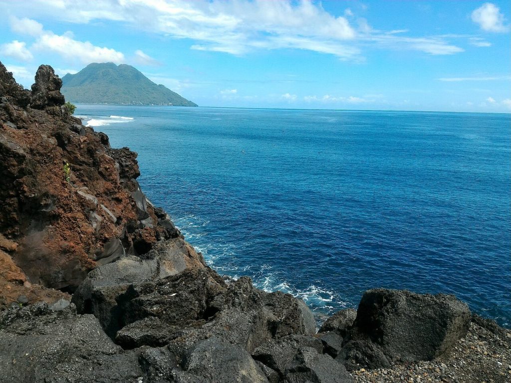 [The dramatic coastline of Ternate in the Maluku Islands, a historic center for the spice trade and a fascinating thing to do in Indonesia.]