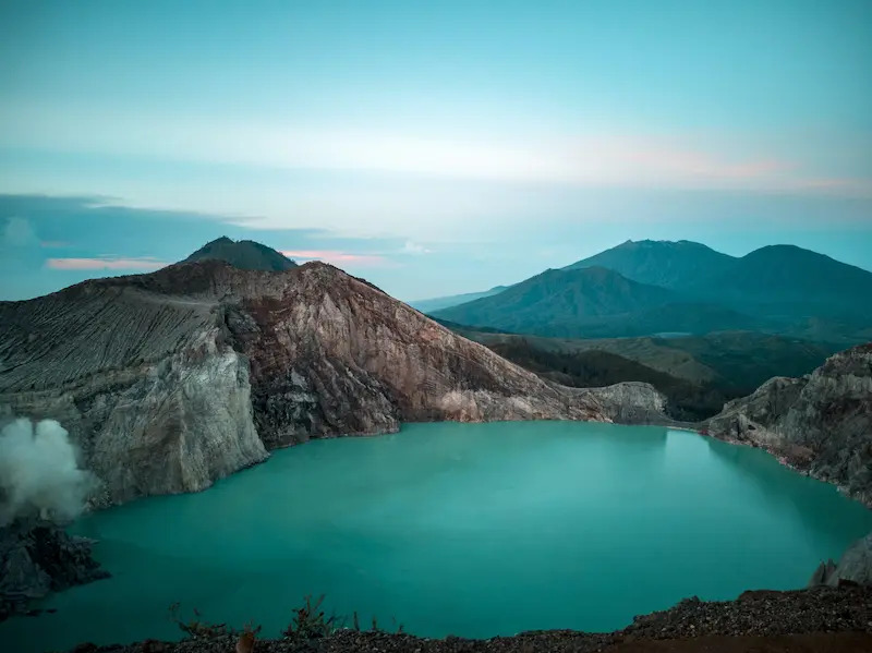 [The ethereal, turquoise-colored Kawah Putih crater lake, a surreal landscape and a must-see for anyone exploring things to do in West Java.]