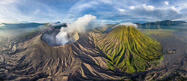 [The active crater of Mount Bromo steaming, with the towering Mount Semeru in the background, a legendary view for visitors to East Java.]