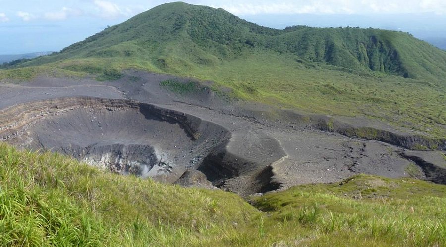 [The vast crater of the dormant Mount Mahawu, offering panoramic views for those looking for adventurous things to do in Indonesia.]