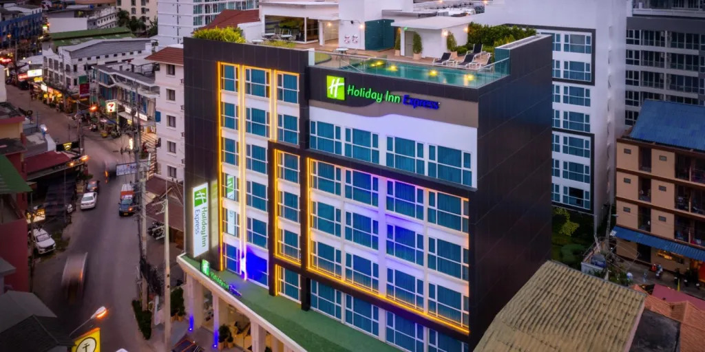 A compact and efficient room at the Holiday Inn Express Pattaya Central, with smart design and a large wall mural depicting a marina.