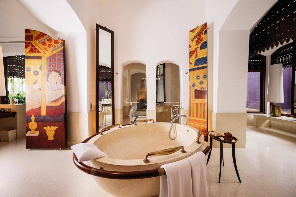 A luxurious private villa at Phulay Bay, a Ritz-Carlton Reserve in Krabi, with its own plunge pool and an outdoor daybed.