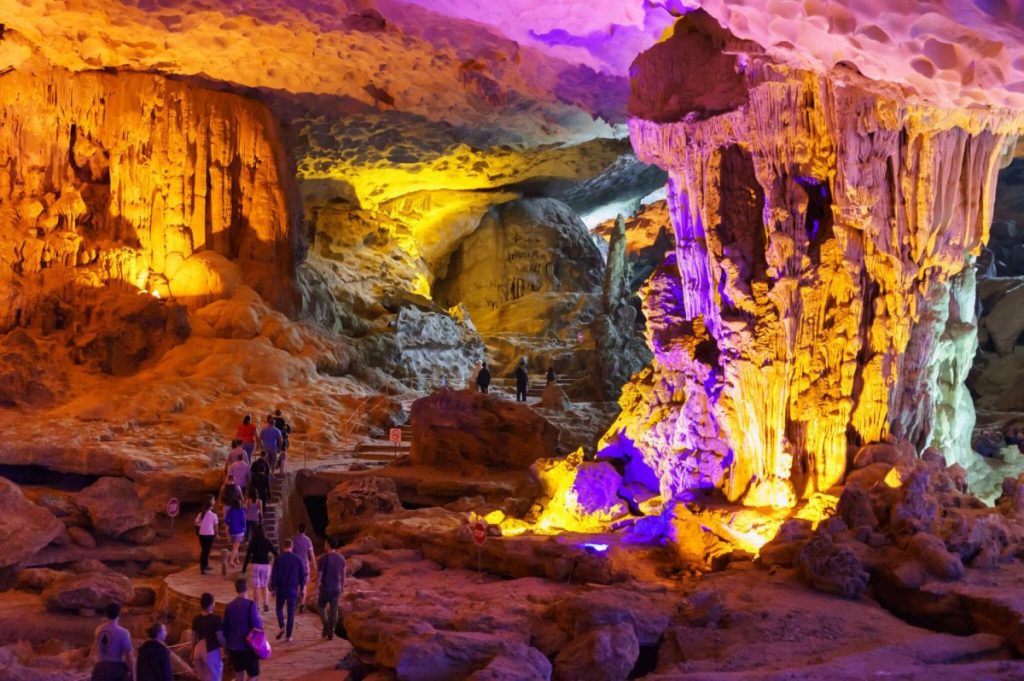 [A serene grotto within Sung Sot Cave, illuminated with a cool blue light, creating an otherworldly atmosphere.]