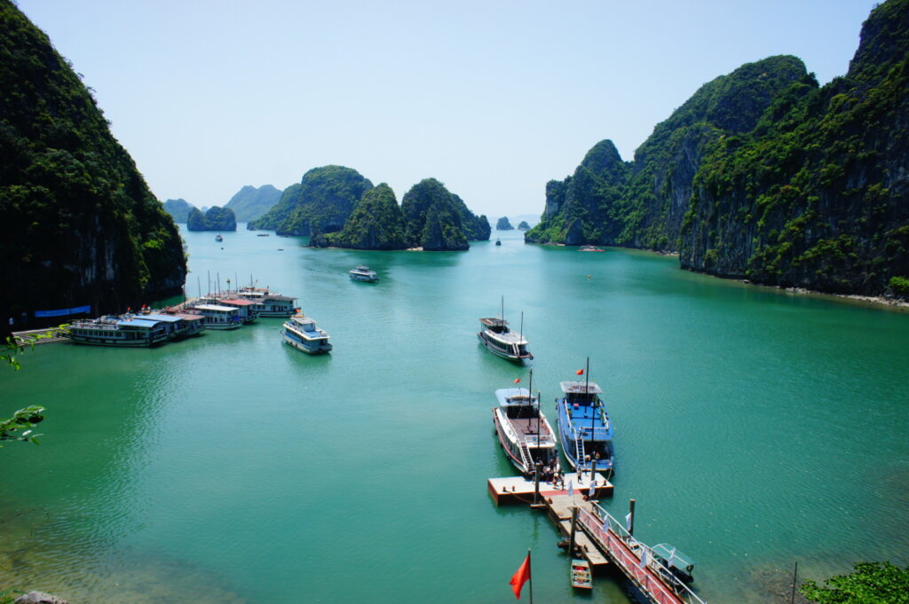 [A fleet of colorful sampan boats docked and ready to take visitors through the Trang An cave complex, a popular activity in this Vietnam travel guide.]
