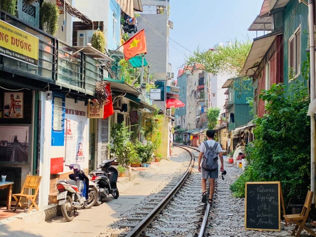 [A narrow alleyway with a railway track running through it, famously known as Hanoi's Train Street, a unique sight in this Vietnam travel guide.]