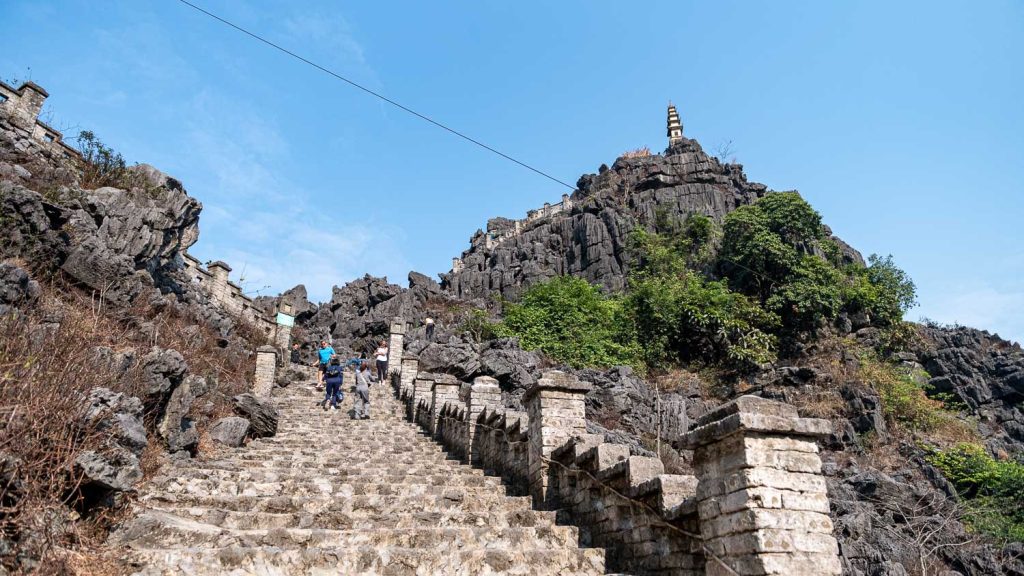 [The stunning pagoda viewpoint at Mua Cave, overlooking the vast and beautiful landscape of Tam Coc.]