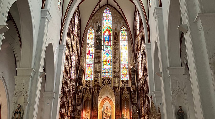 [The beautiful and intricate stained-glass windows inside St. Joseph Cathedral, a historic landmark in Hanoi.]